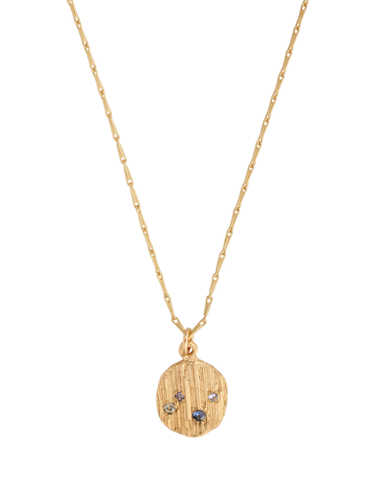 Picture of gold necklace with textured pendant set with 4 blue sapphires.