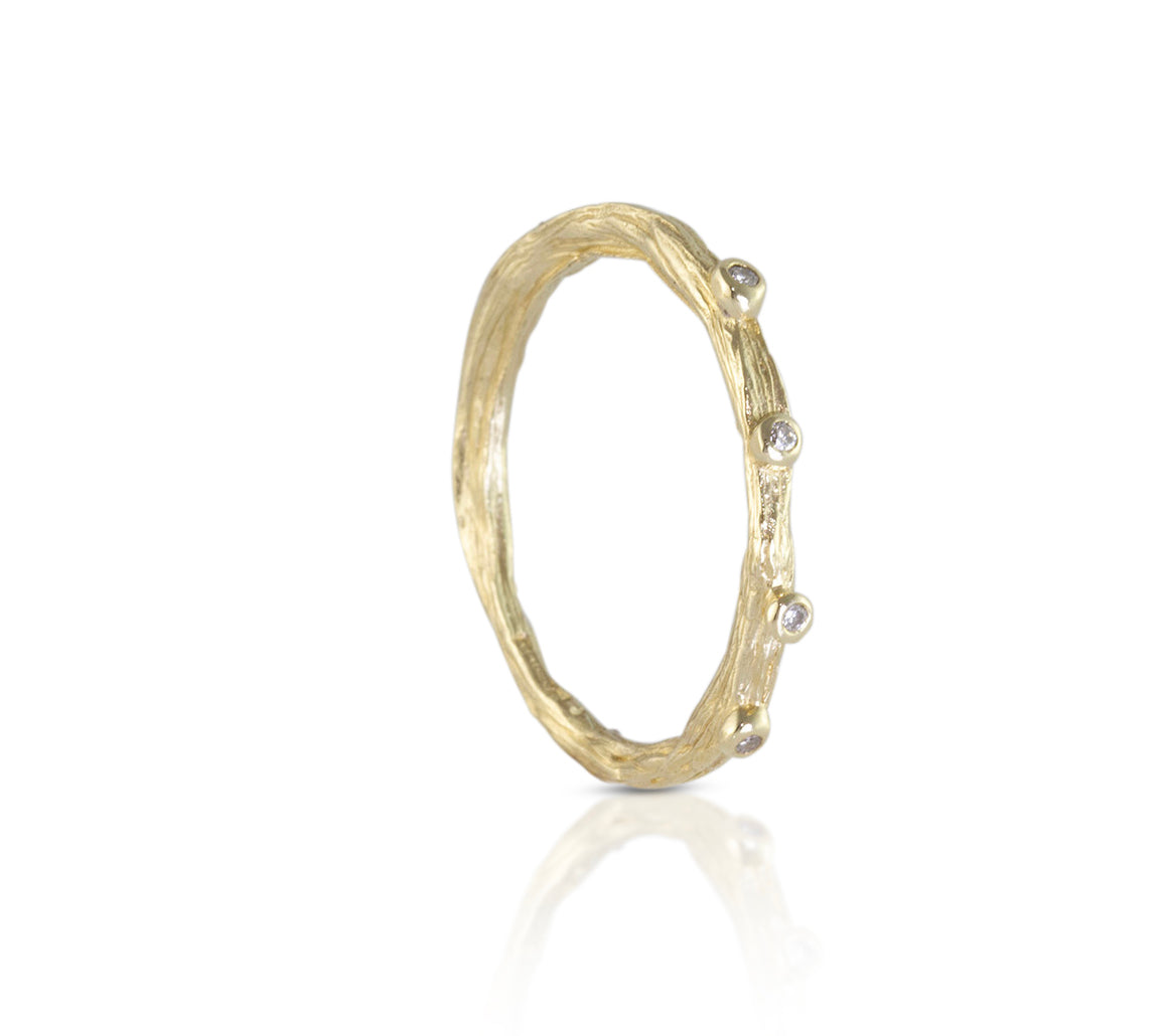 Alternative wedding band organic cast from a twig with diamonds.