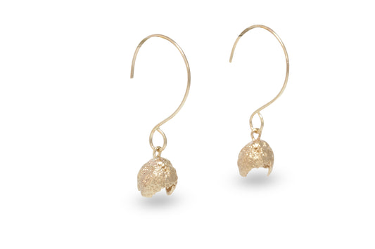A pair of gold plated silver earrings cast from acorns with round wire handmade hoops.