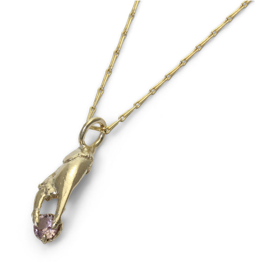 Crab claw pendant in gold holding a little garnet in pink, perfect valentines gift