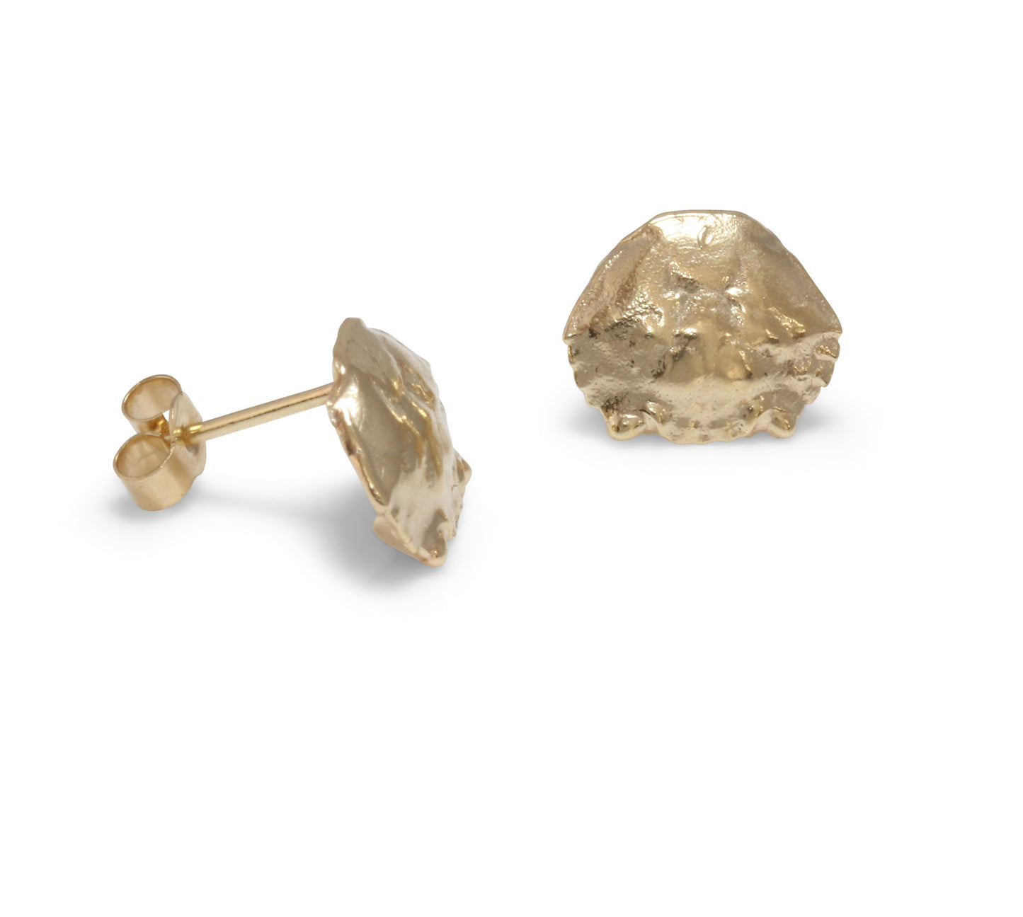 A handmade pair of tiny crab shell studs cast in yellow gold. Perfect to wearing as a stacking earring on your earlobes. Side view of handmade pins with butterfly fastenings on them. .