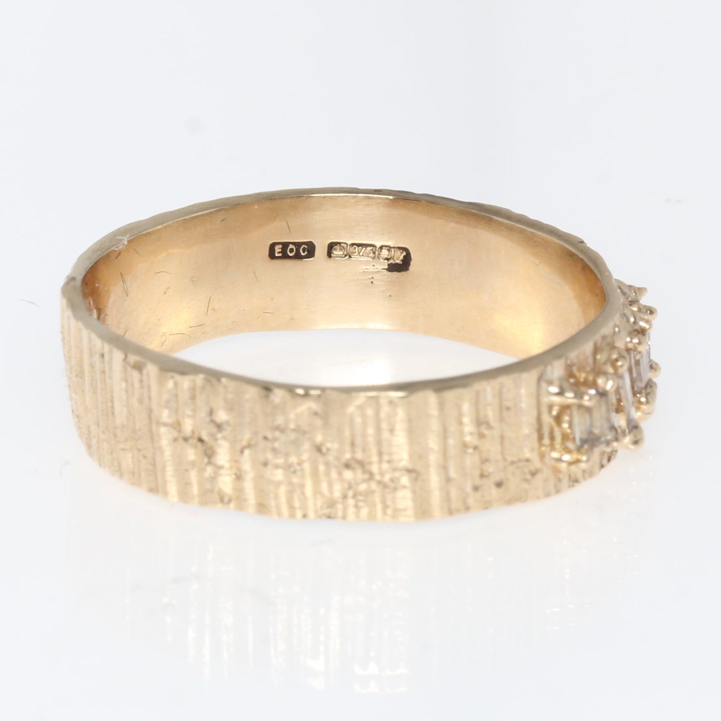 Gold ring with diamonds on a white background
