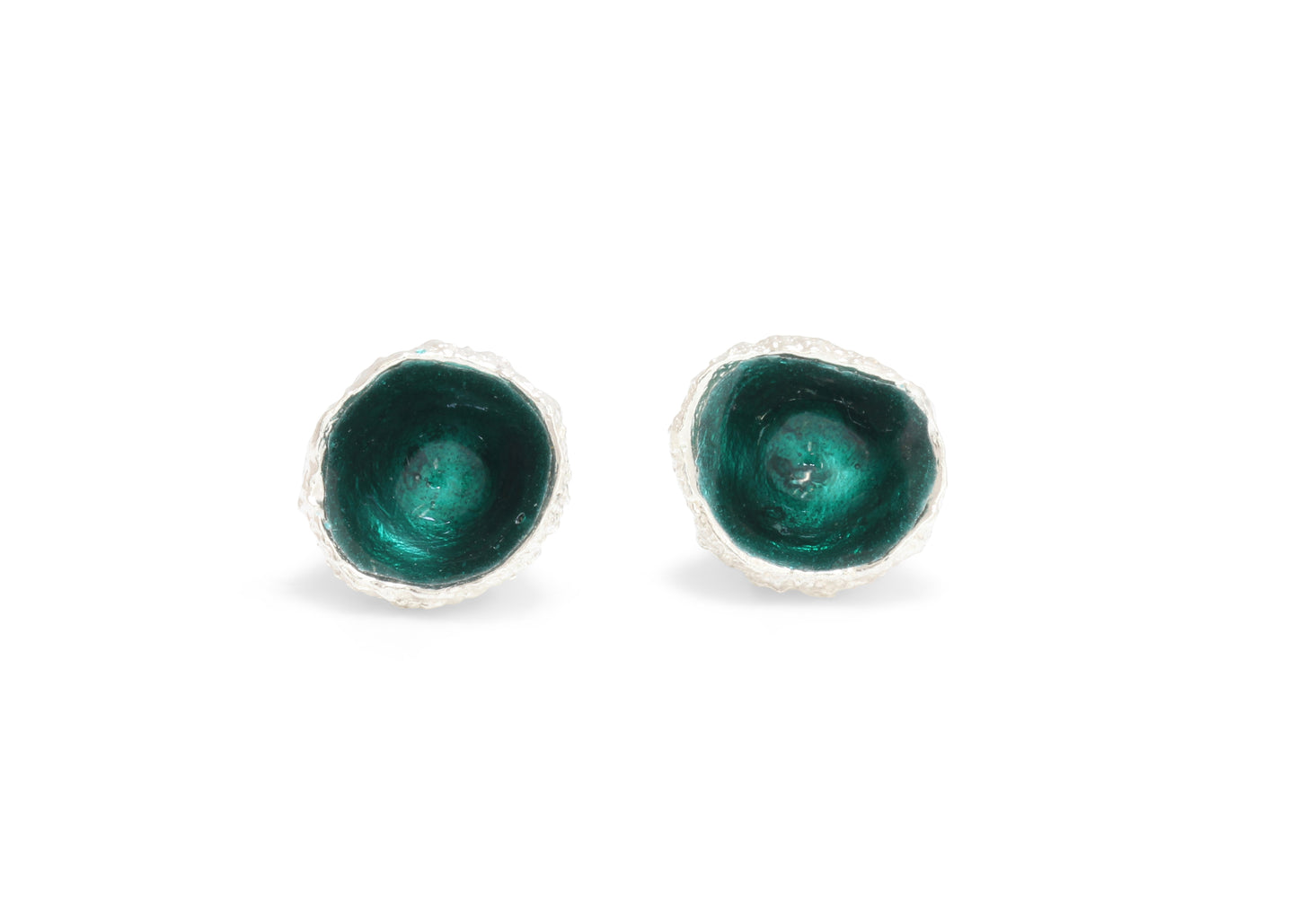 A pair of acorn earrings in silver with green enamel like a pine tree inside.