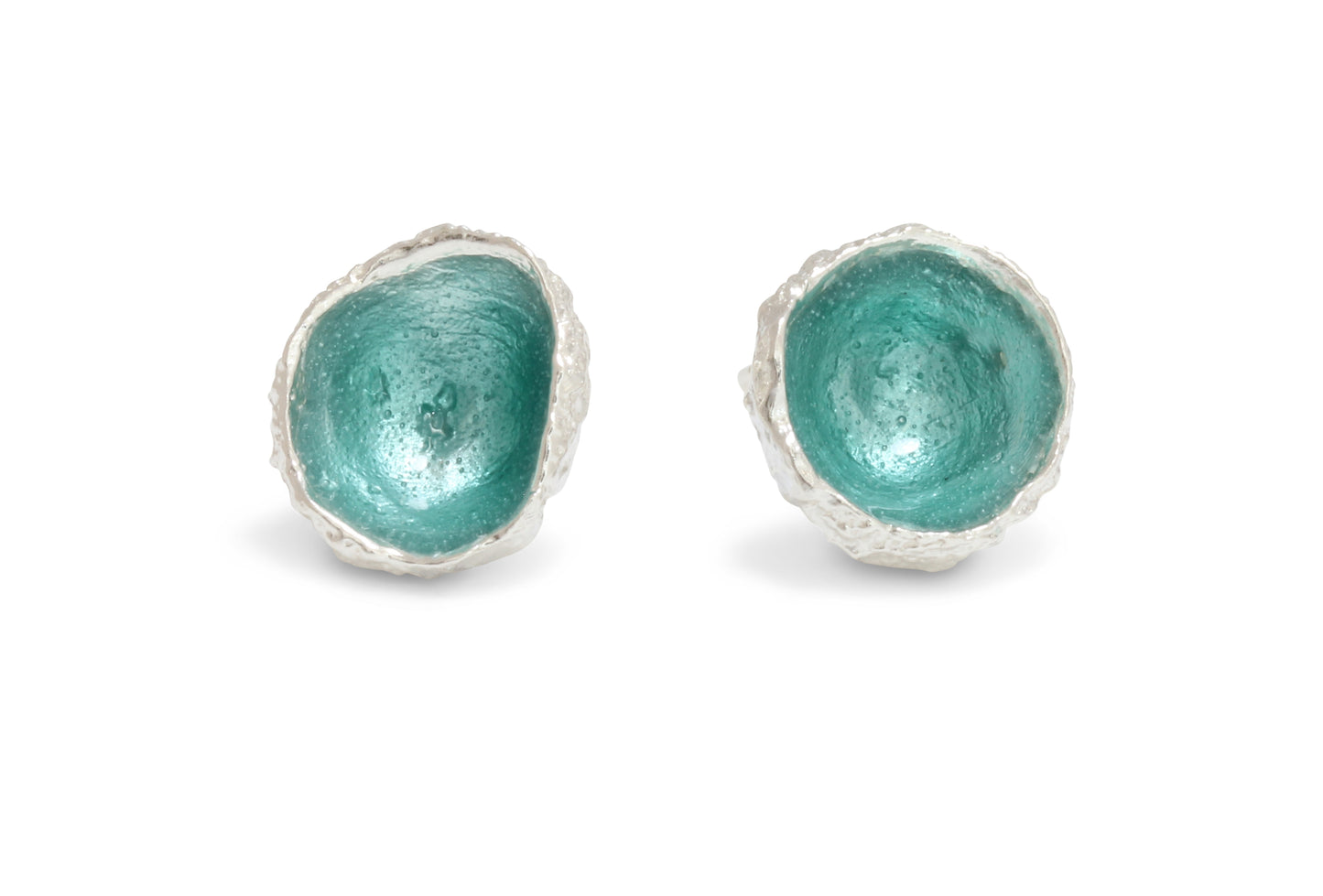 A silver pair of earrings cast from acorns with hand fired enamel in seafoam colour inside.