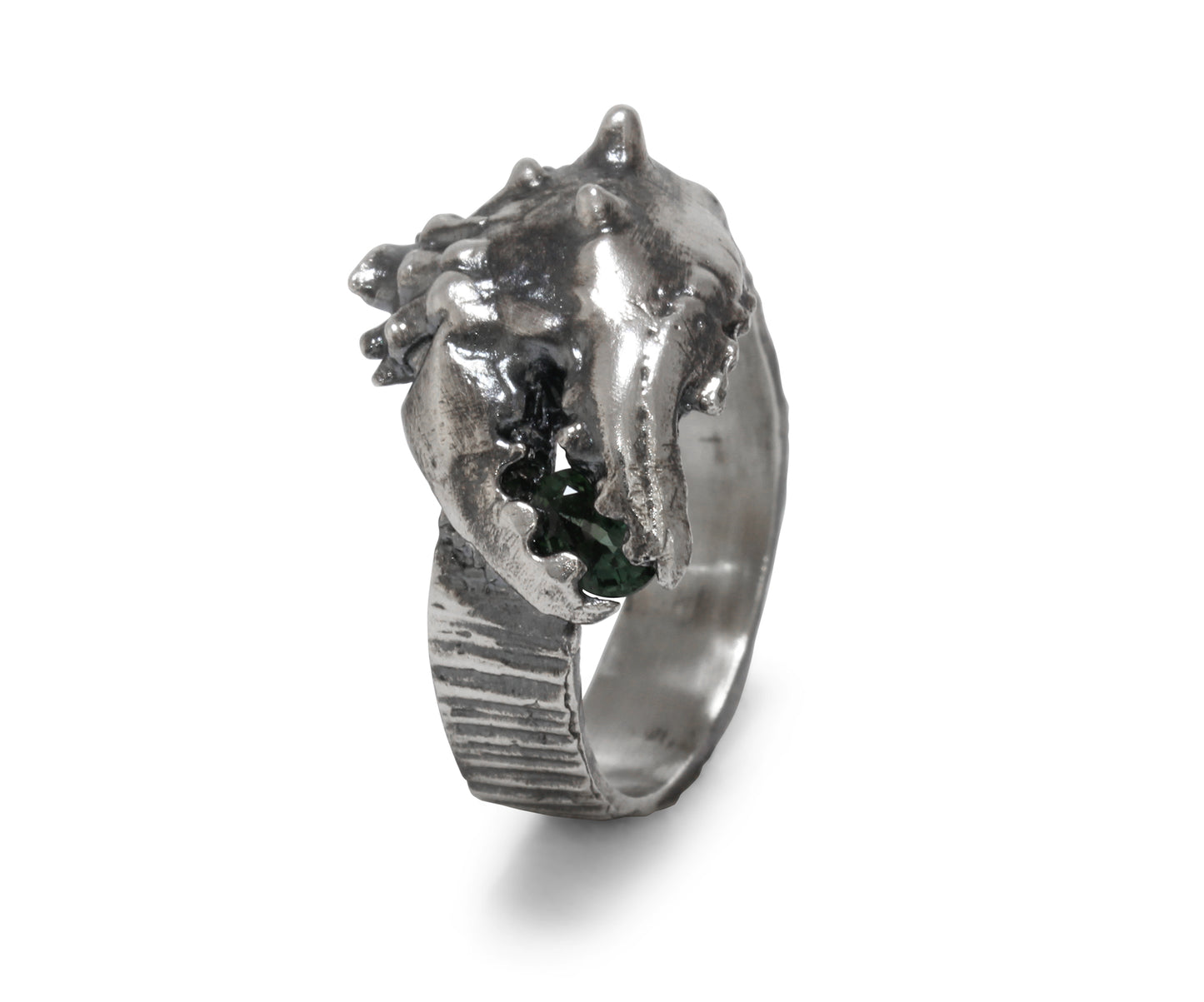 A blackened silver ring shaped like a crab claw holding a green sapphire gemstone. Perfect for a mans Christmas present. Side view here of the ring.