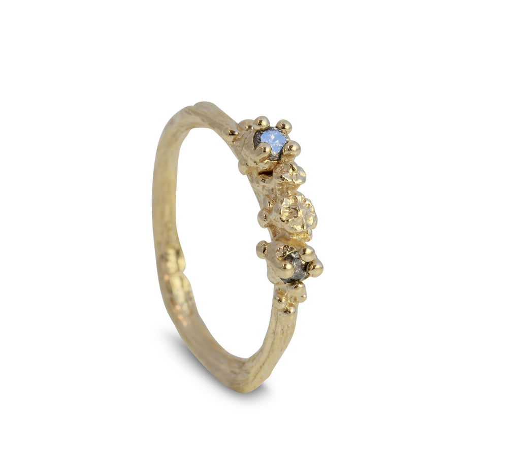 Organic engagement ring cast from twigs and berries with champagne diamonds set in