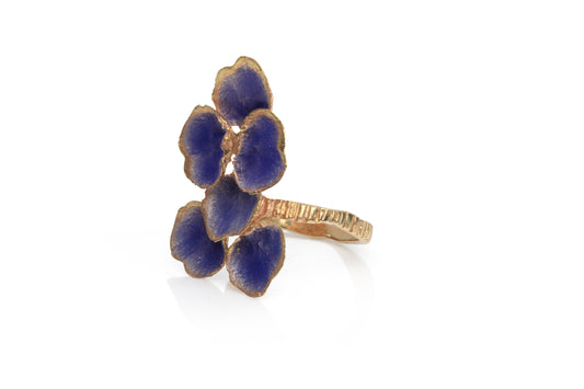 Side view of rose gold ring handmade by Eily O Connell featuring contemporary purple enamel.
