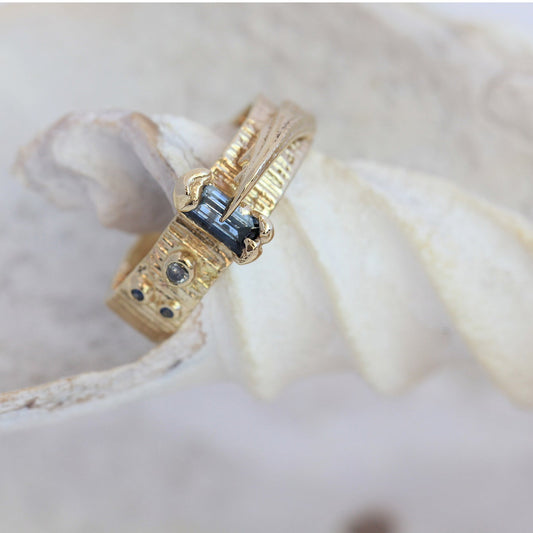thick gold and blue sapphire unique handmade engagement ring with crab claw and textures