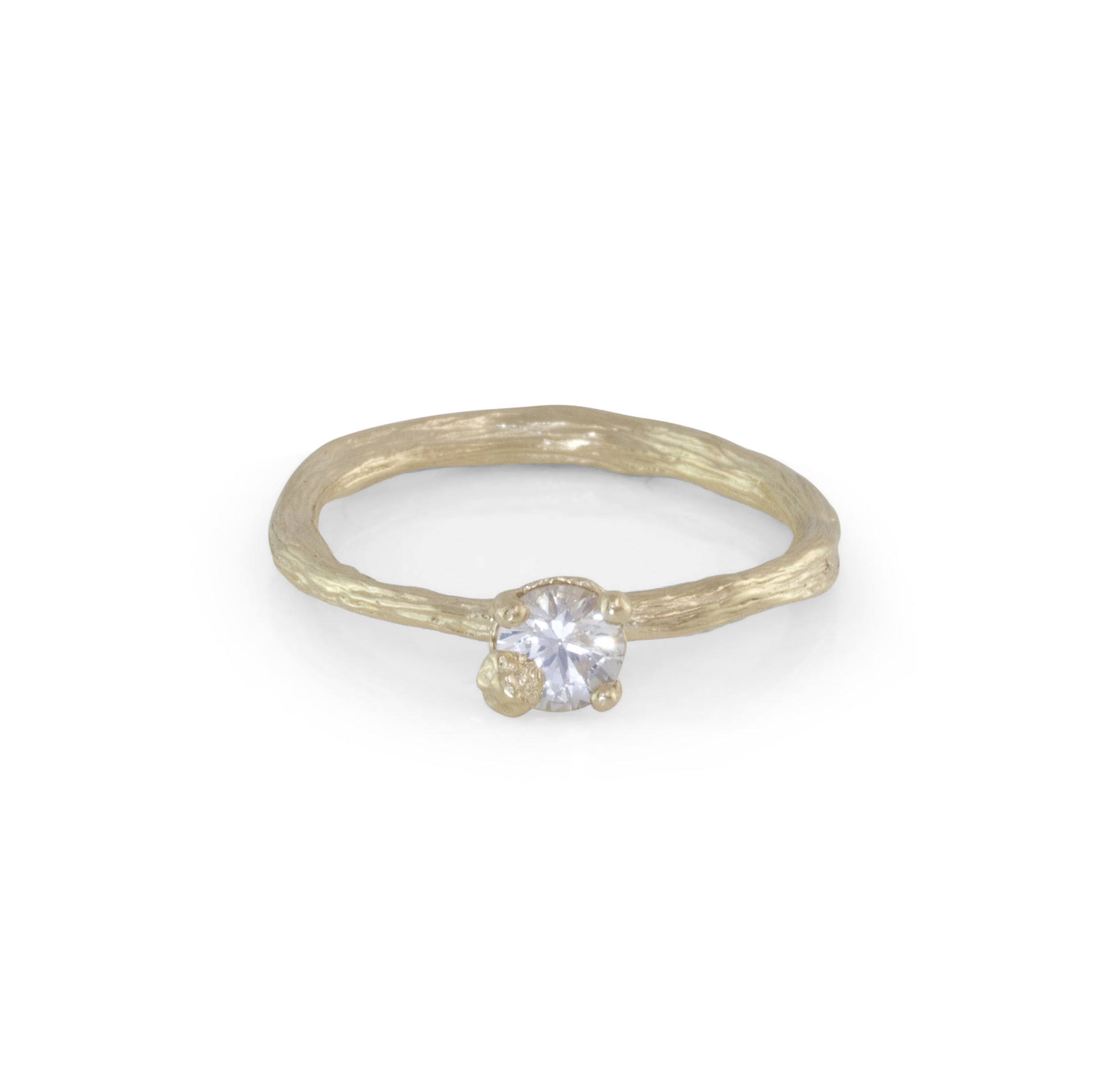 gold organic textured ring with cast berry on top of a white sapphire. Nice alternative to a diamond solitaire ring. 