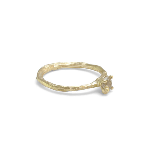 gold organic textured ring with cast berry on top of a white sapphire. Nice alternative to a diamond solitaire ring. Side view here. 
