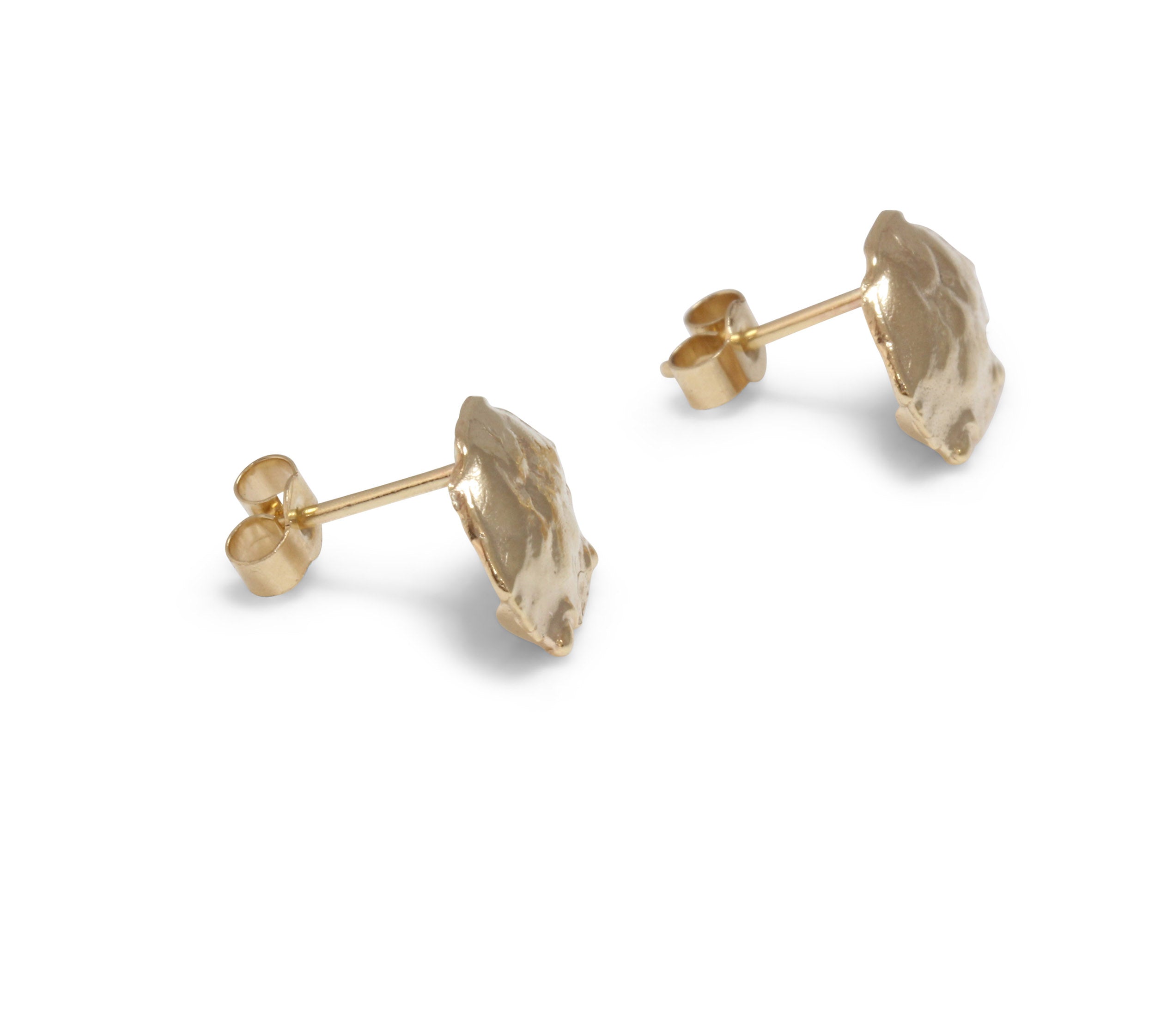  A pair of tiny crab shell studs cast in yellow gold. Perfect to wearing as a stacking earring on your earlobes. Side view of handmade pins with butterfly fastenings on them. . 