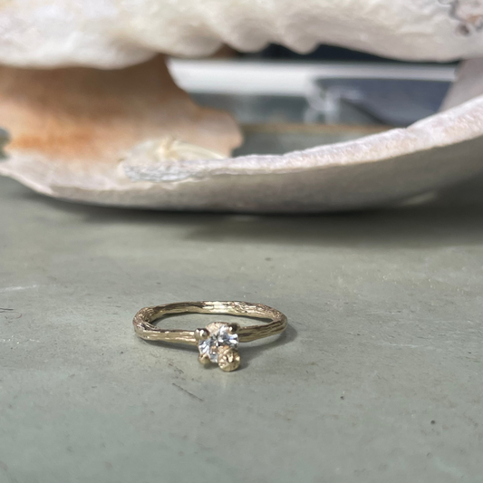 gold organic textured ring with cast berry on top of a white sapphire. Nice alternative to a diamond solitaire ring. Perfect alternative engagement ring. 