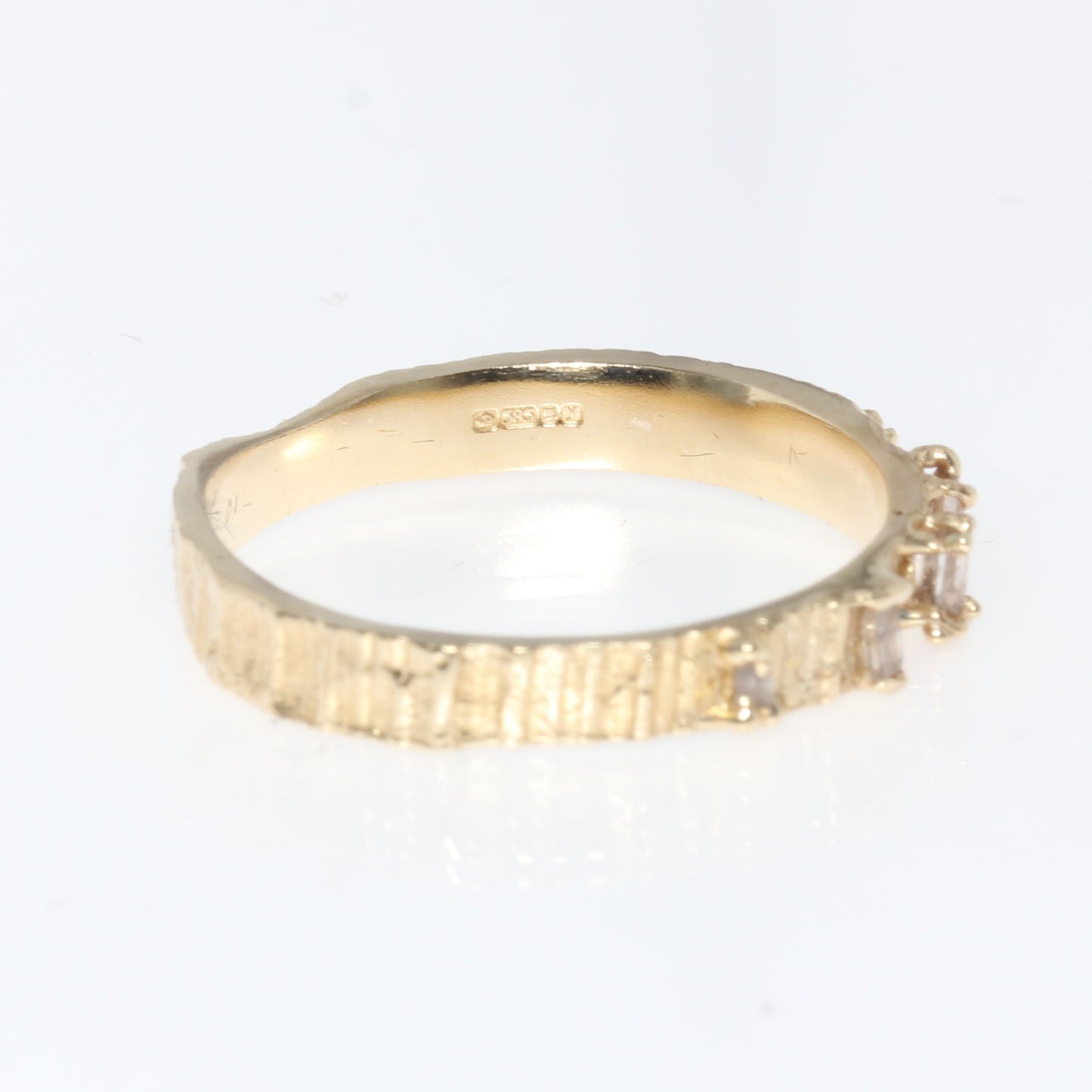 Gold ring on a white background shopwing 14ct gold hallmark