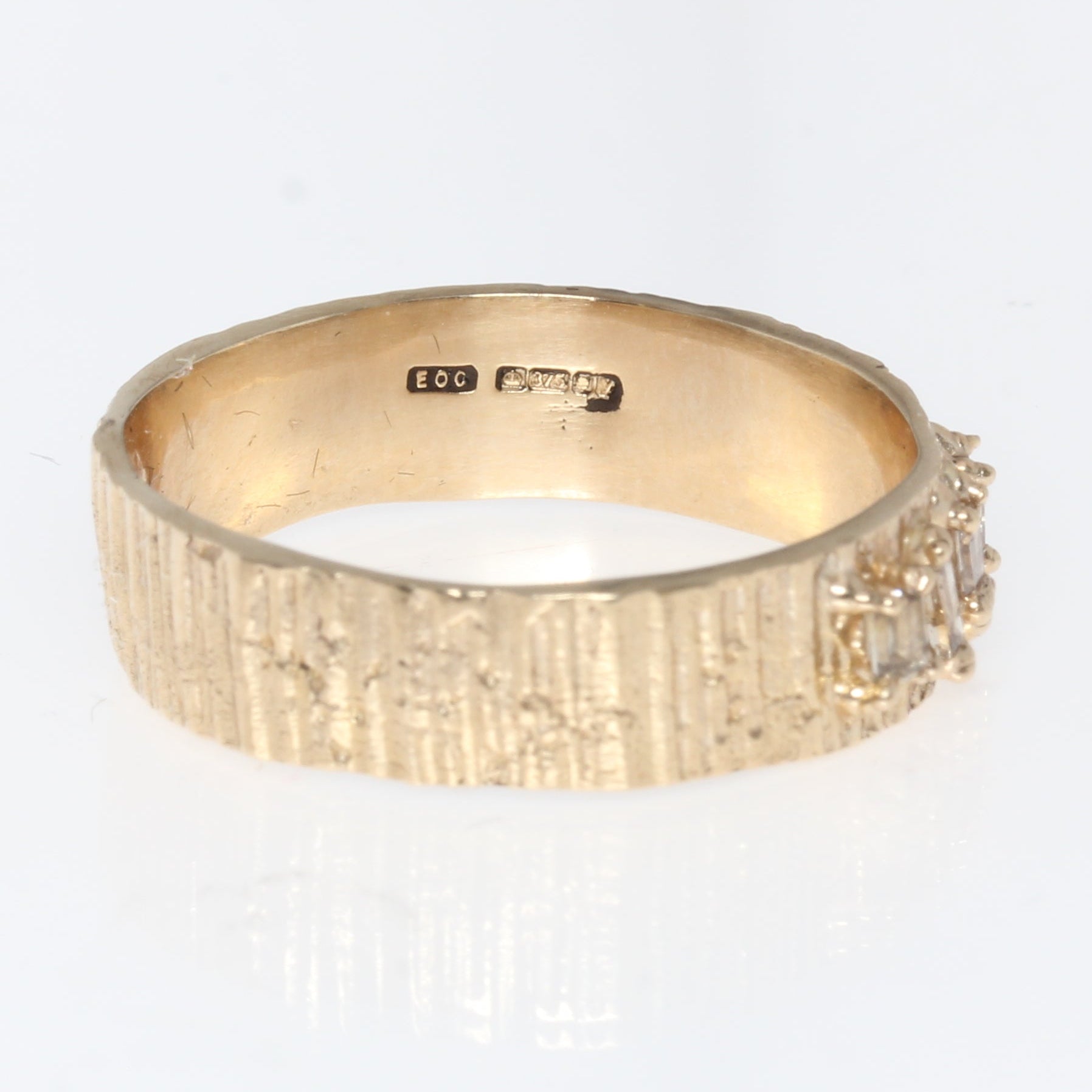 Gold ring with diamonds on a white background