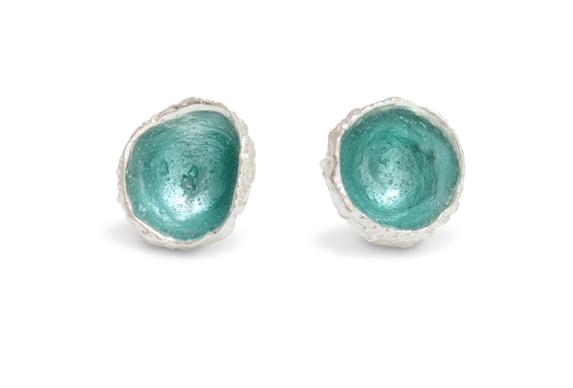 A silver pair of earrings cast from acorns with hand fired enamel in seafoam colour inside. Handmade earrings in silver. 