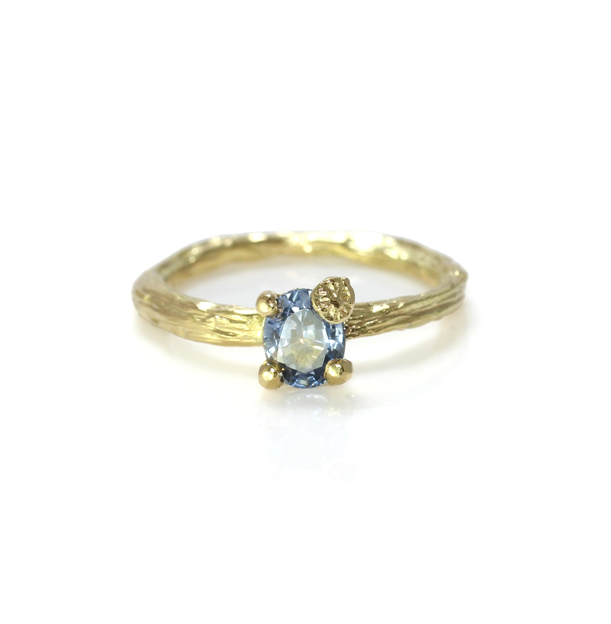 A buttery 18 carat yellow gold alternative engagement ring with a blue sapphire in oval gemstone shape. Soltaire ring style. 