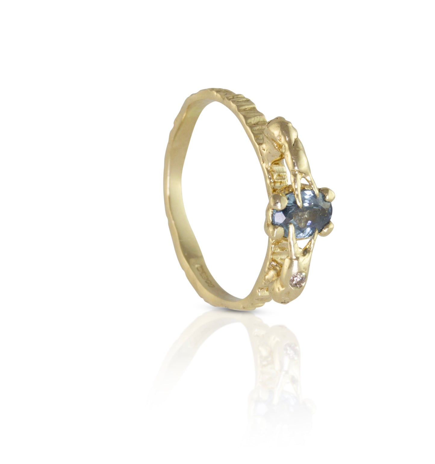 Alternative engagement ring with blue sapphire and champagne diamond with crab claws holding the blue precious gemstone. 
