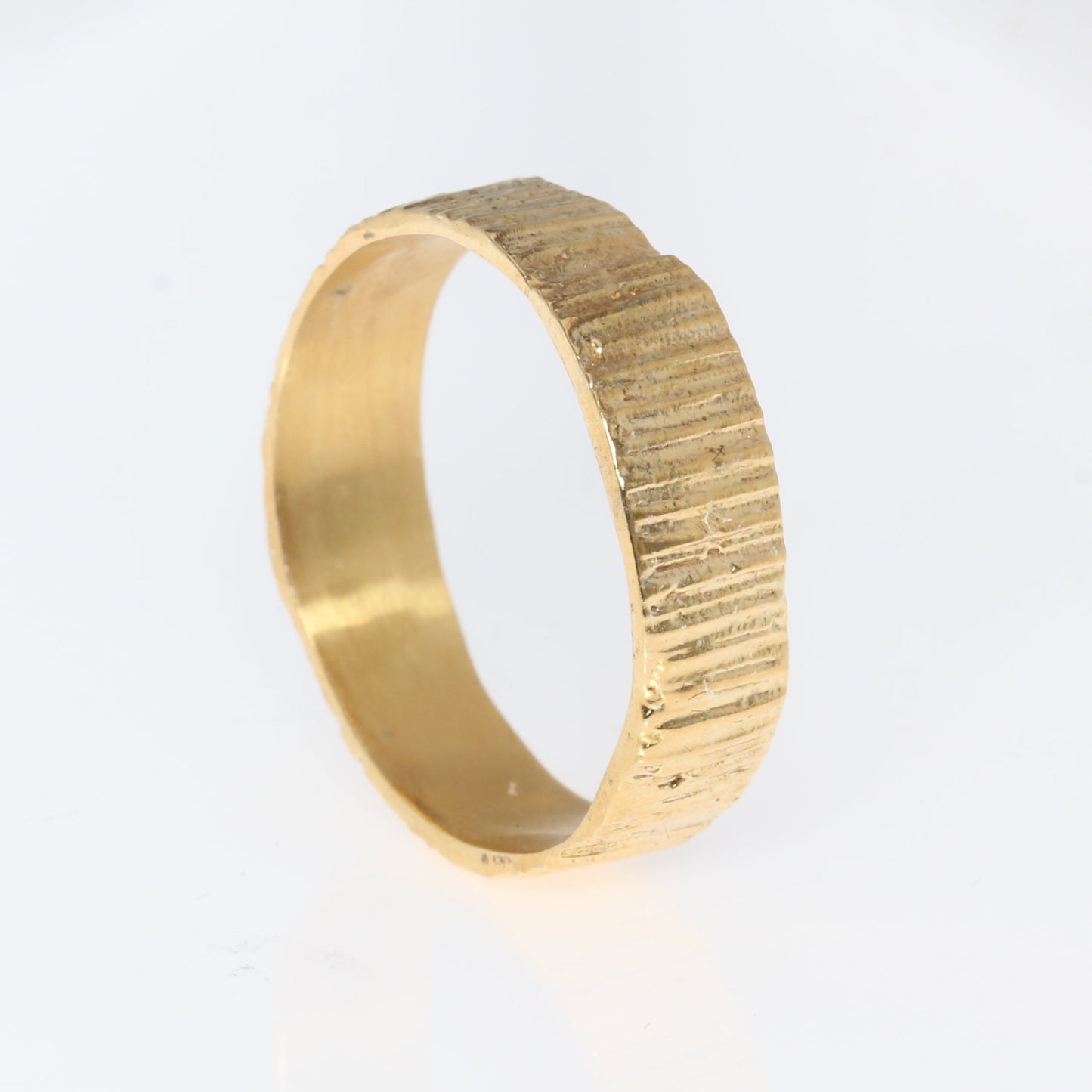 gold wedding band 6mm textured on white background