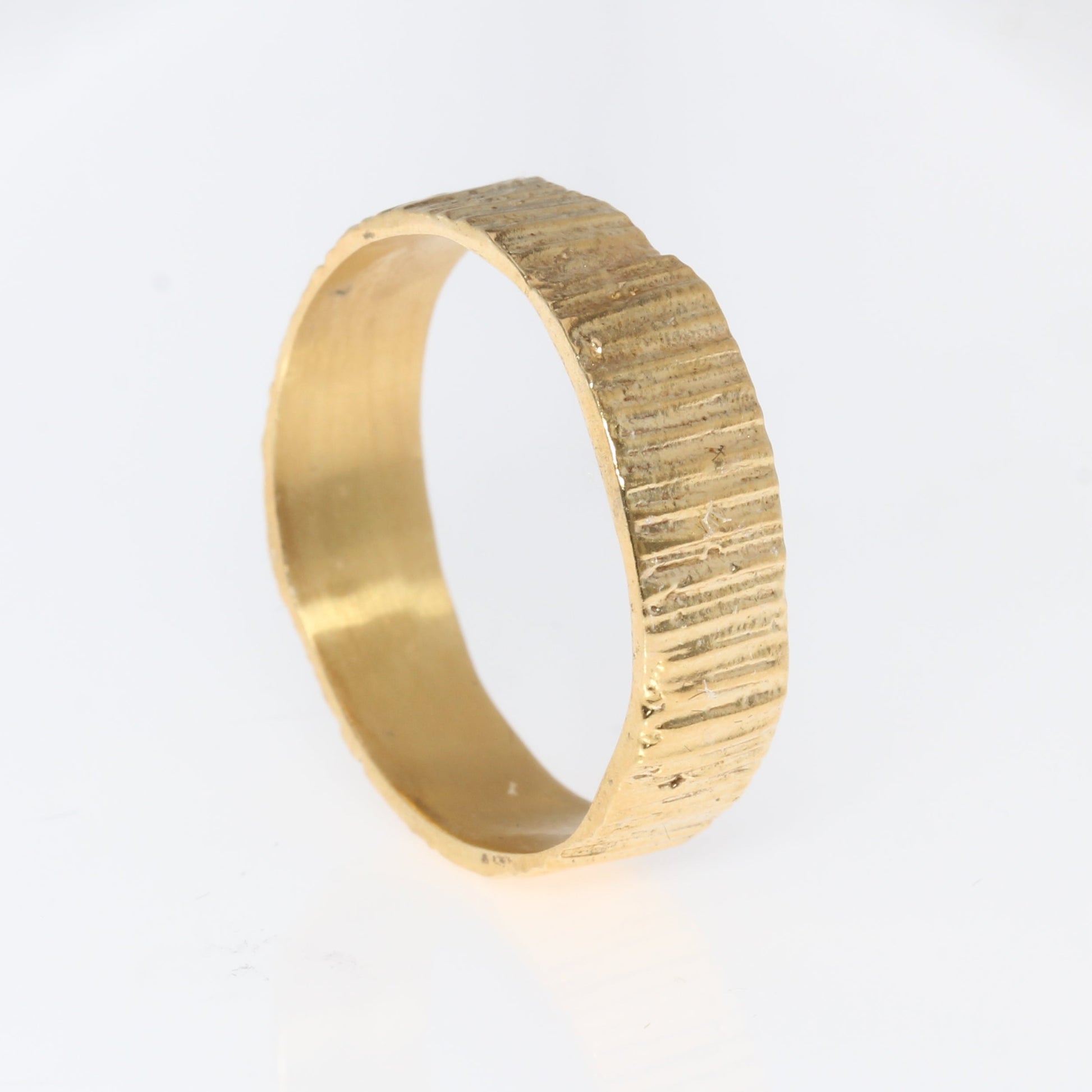 gold wedding band 6mm textured on white background
