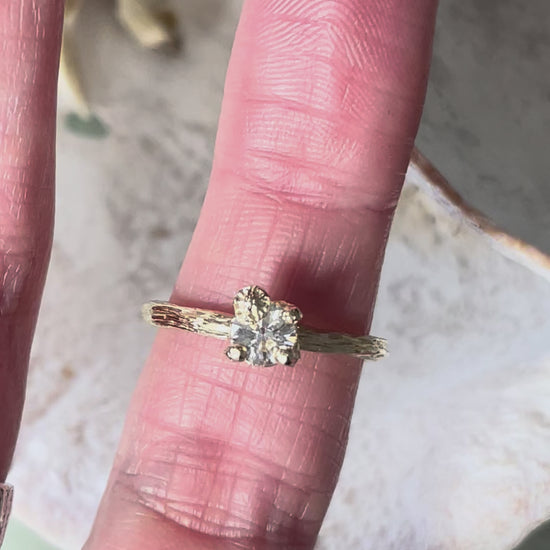 gold organic textured ring with cast berry on top of a white sapphire. Nice alternative to a diamond solitaire ring. Perfect alternative engagement ring. 