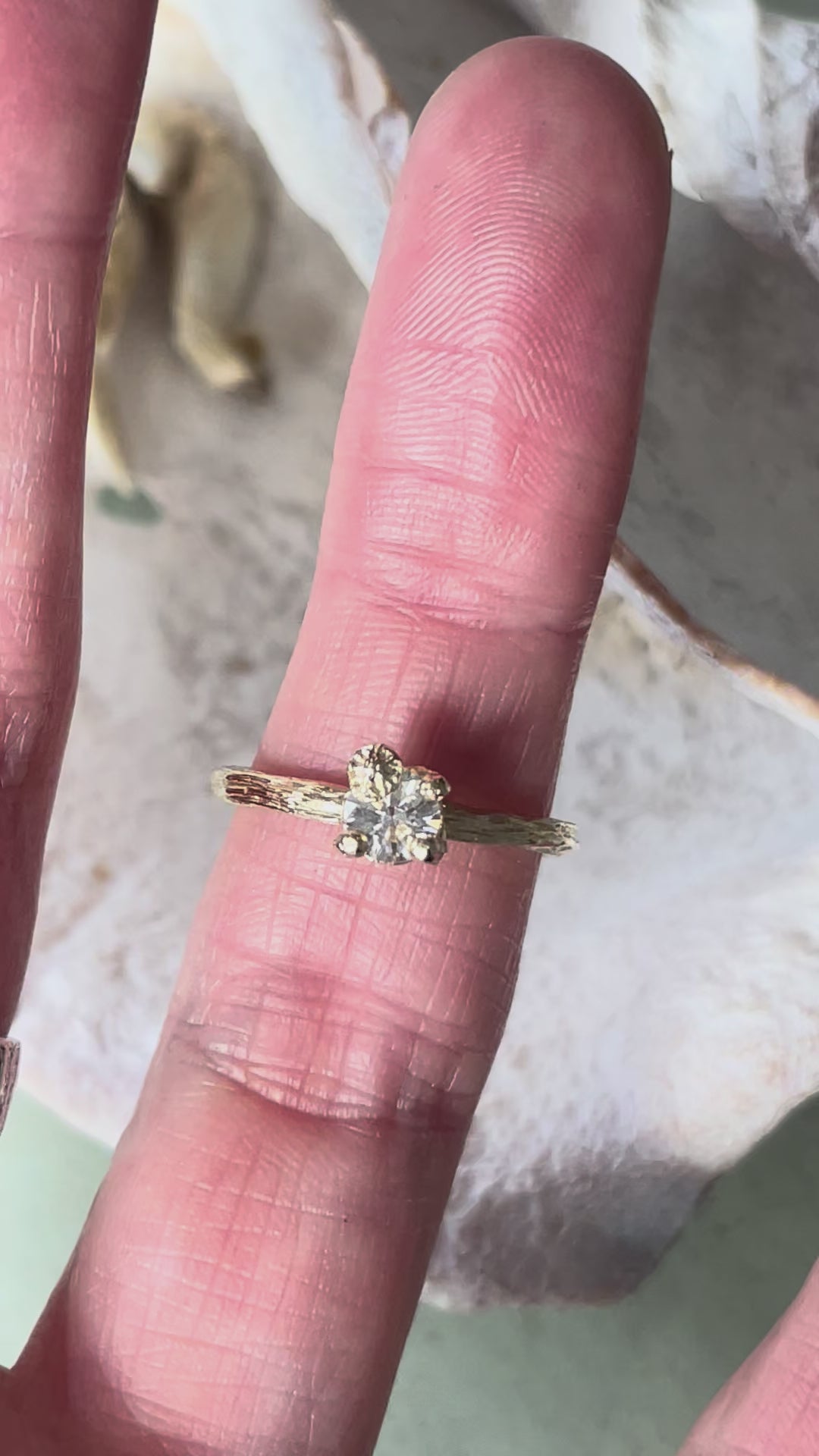 gold organic textured ring with cast berry on top of a white sapphire. Nice alternative to a diamond solitaire ring. Perfect alternative engagement ring. 