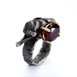 One of a kind contemporary statement ring cast from a dung beetle. With red garnet gemstone as his head held in 14 carat yellow gold.