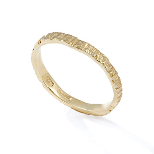 Picture of a gold alternative wedding band that has been cast from bark so it has organic grooves and textures. Handmade by Irish jeweller Eily O Connell who lives in Bristol. 
