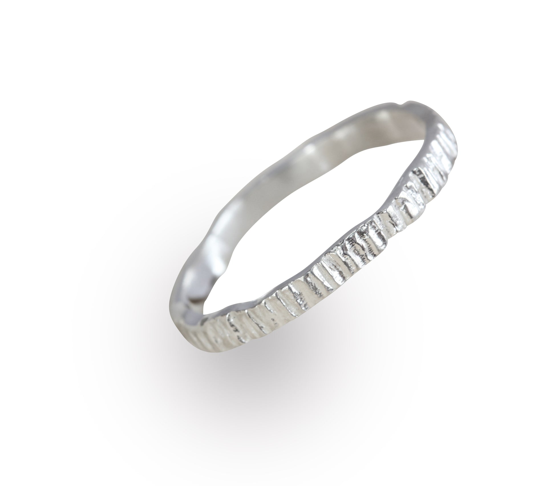 Picture of a silver or white gold alternative wedding band. It has been cast from bark so it has organic grooves and textures. Handmade by Irish jeweller Eily O Connell who lives in Bristol. 