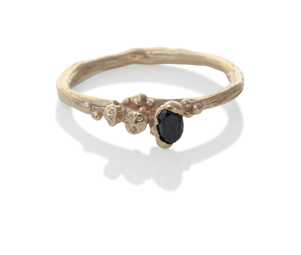 Handmade gold ring with black diamond offset to the side. Berry detailing in the ring too. 