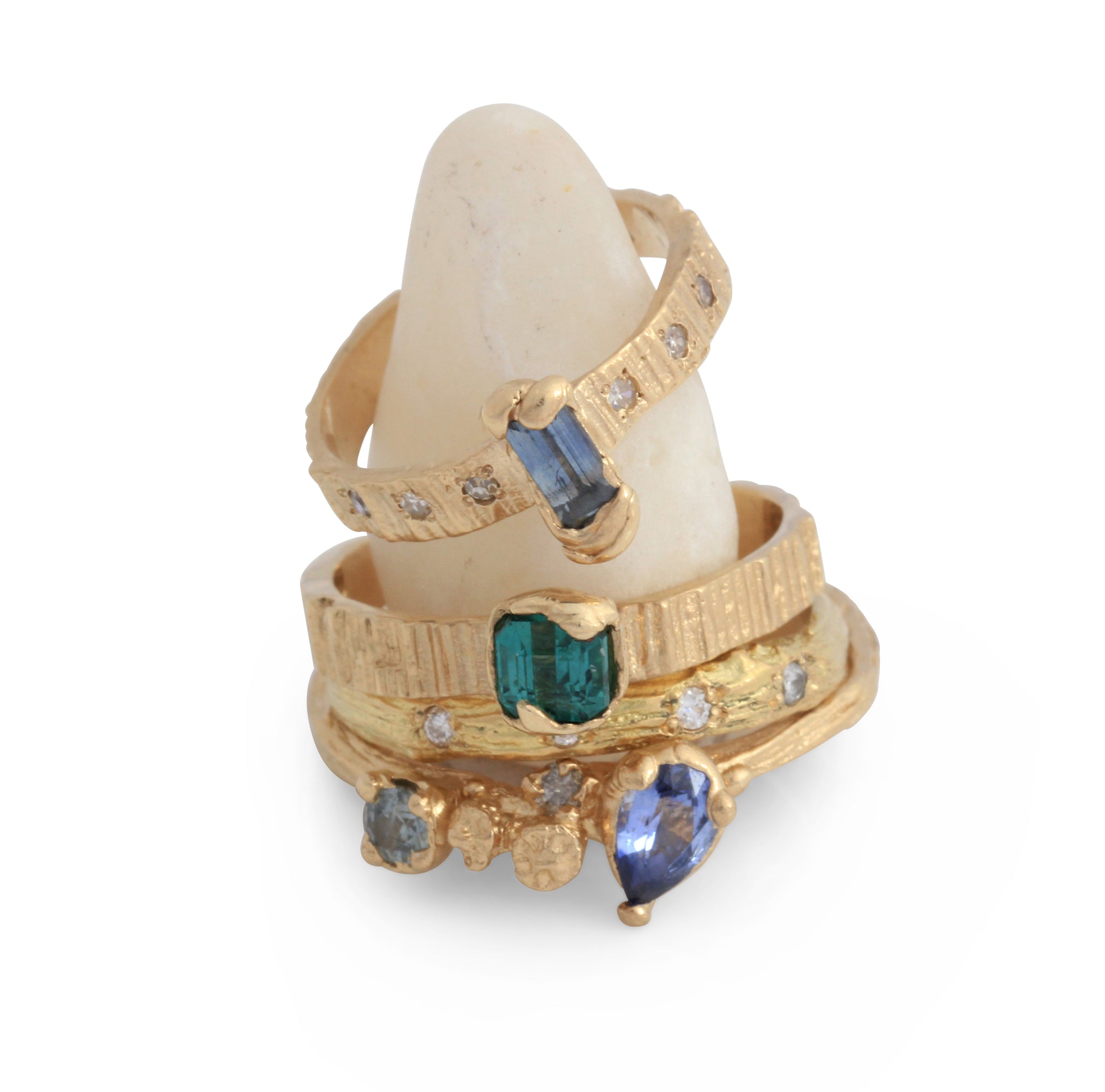 Stack of contempporary gold rings with various gemstones handmade by Irish jeweller Eily O Connell in Bristol. 