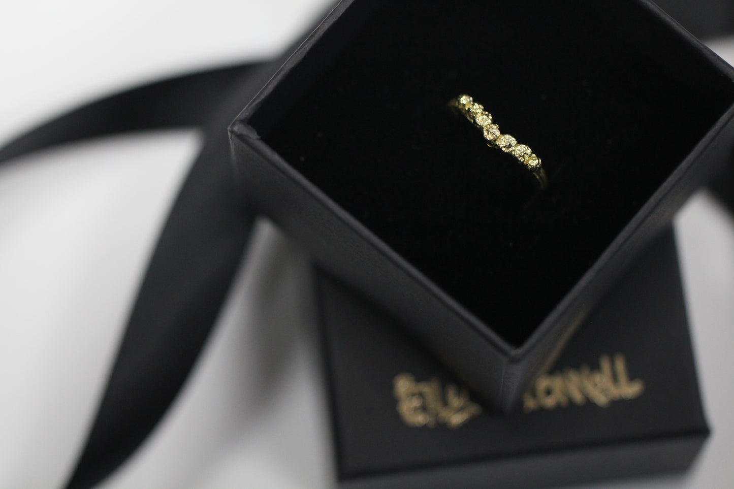 Chevron V shape gold ring cast from twigs and berries in a black box