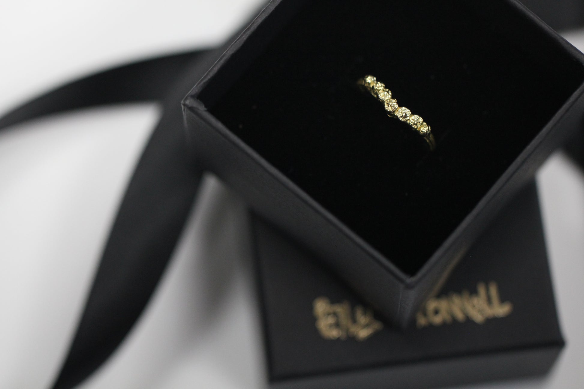 Chevron V shape gold ring cast from twigs and berries in a black box