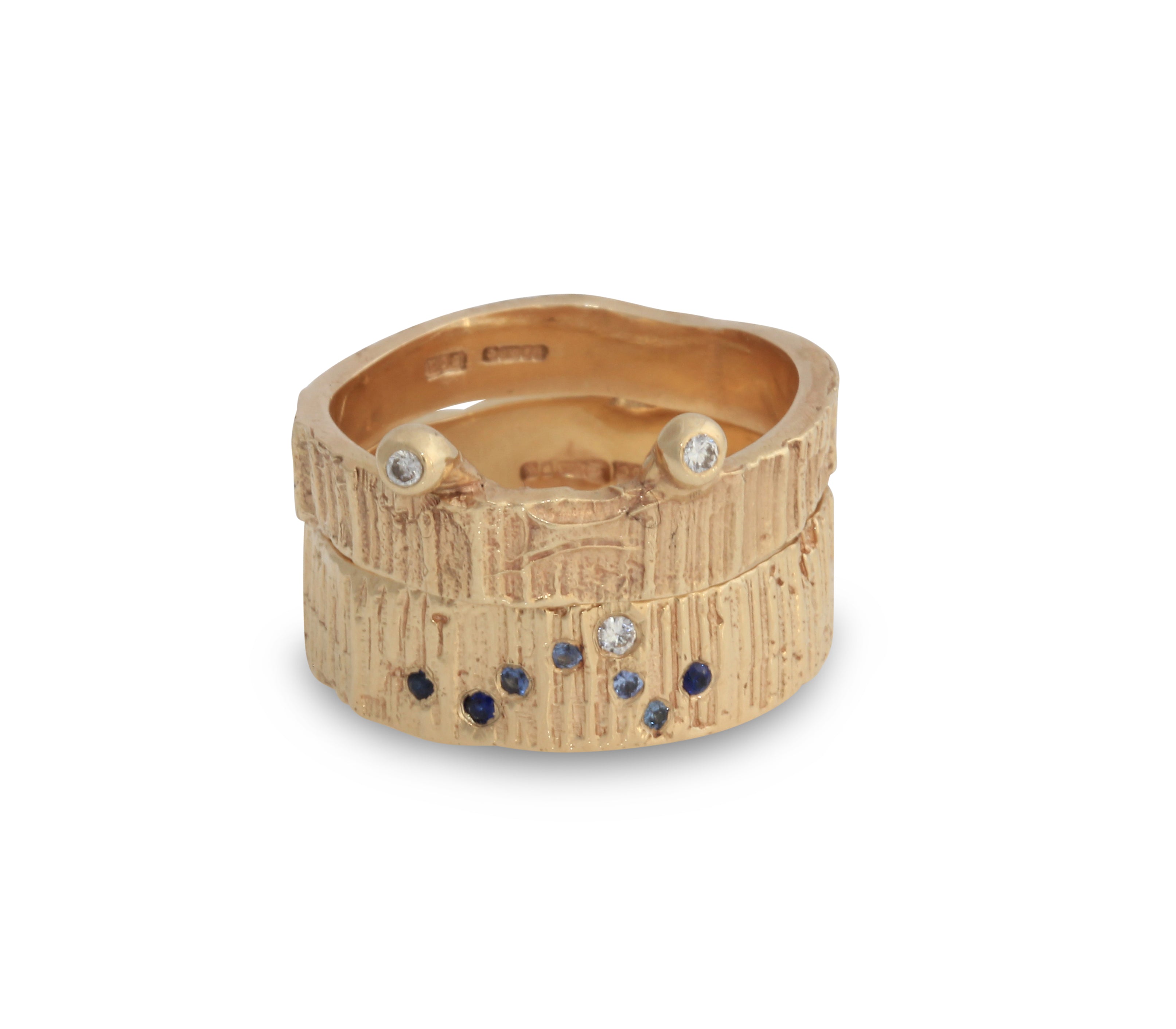 Gold rings stacked on top of one another. sapphires and diamonds set in the rings